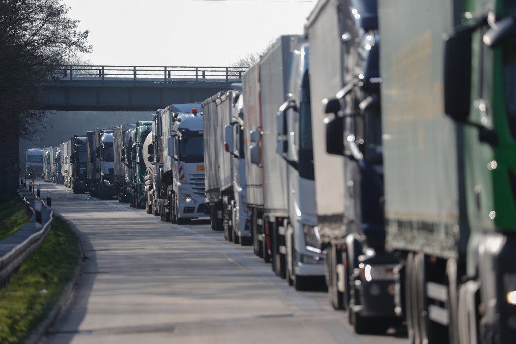 Trucks are stuck in a traffic jam around 1km from the German-Polish border near the eastern German town of Frankfurt (Oder) due to travel restrictions to counteract the spread the new corounavirus COVID-19 on March 18, 2020. - Poland re-opened the border for cars today for returning Polish natinals and transit to the Baltic EU states. (Photo by Odd ANDERSEN / AFP)